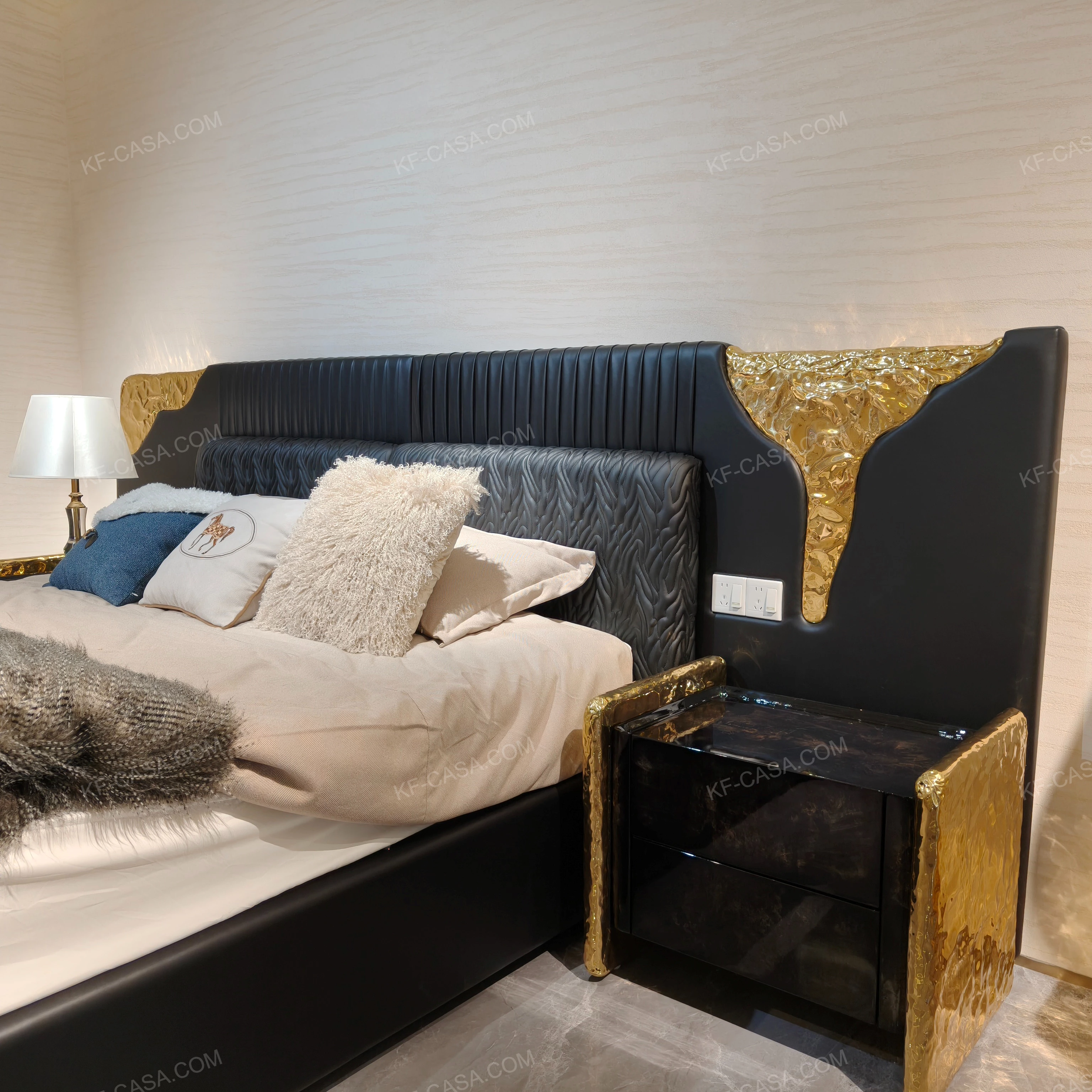 Black Leather Upholstered Bed with Textured Gold Accents, Patterned Quilted Detailing & Brass Hardware Feet